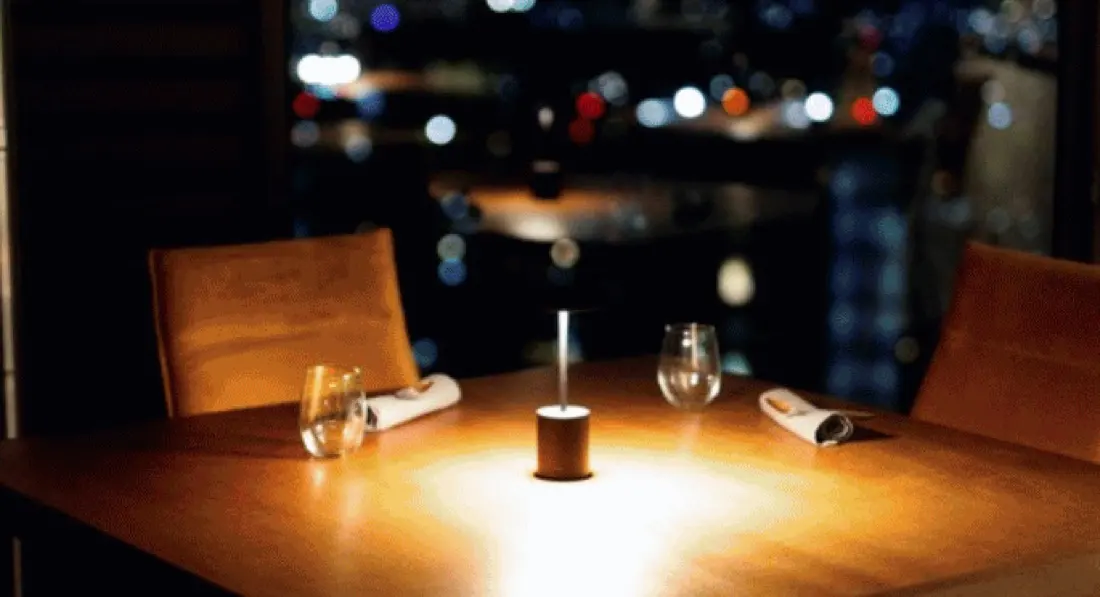 Mesa de restaurante al atardecer con luz de vela
